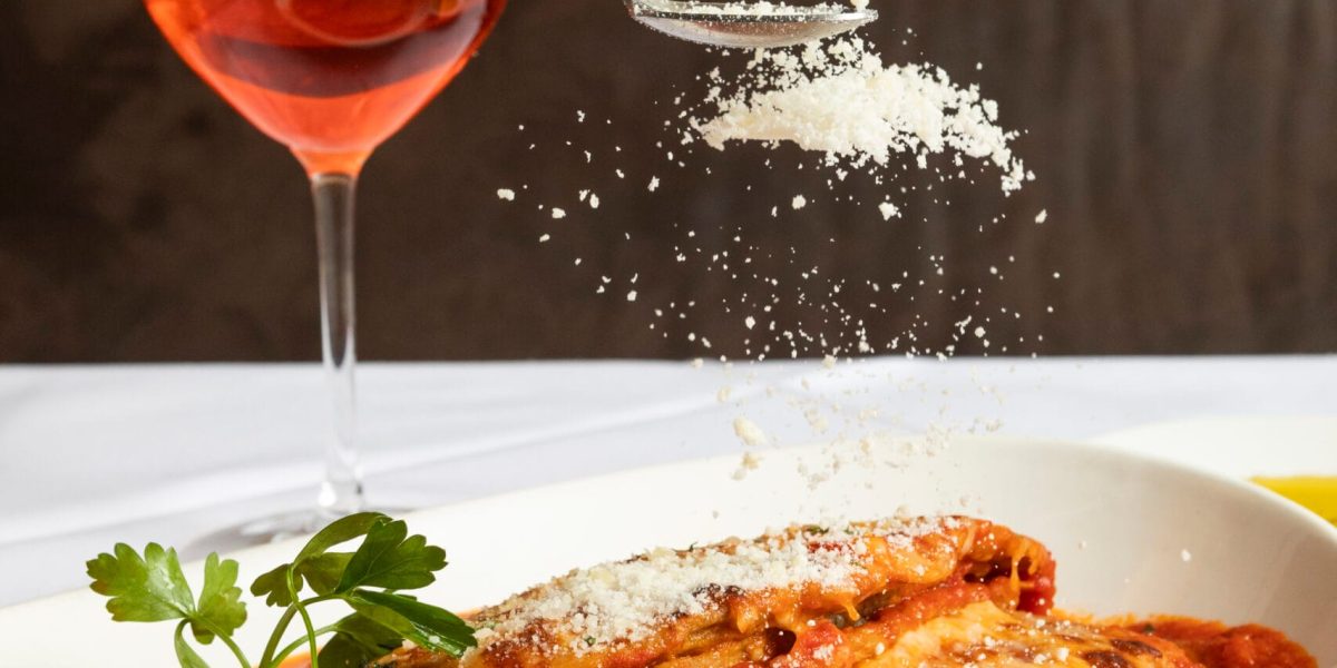cheese falling on eggplant parmesan